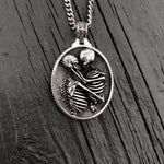 Silver necklace with detailed skeleton pendant, intricate design | Moon Raven