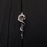 Silver snake coiled on black background, sleek texture | Moon Raven