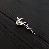 Silver snake pin on wooden table, intricate design | Moon Raven