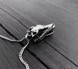 Black & white photo of necklace with skull pendant | Moon Raven